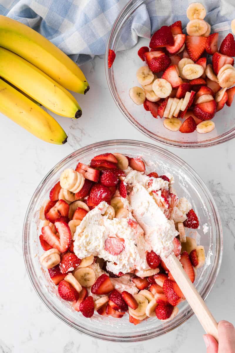 folding in the fruit to the cheesecake pudding mix.