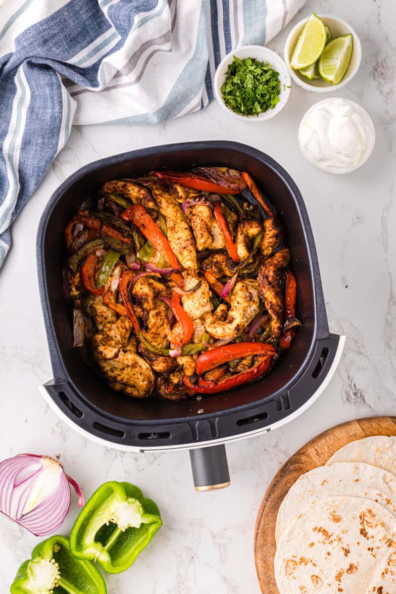 chicken fajitas in the air fryer basket. 