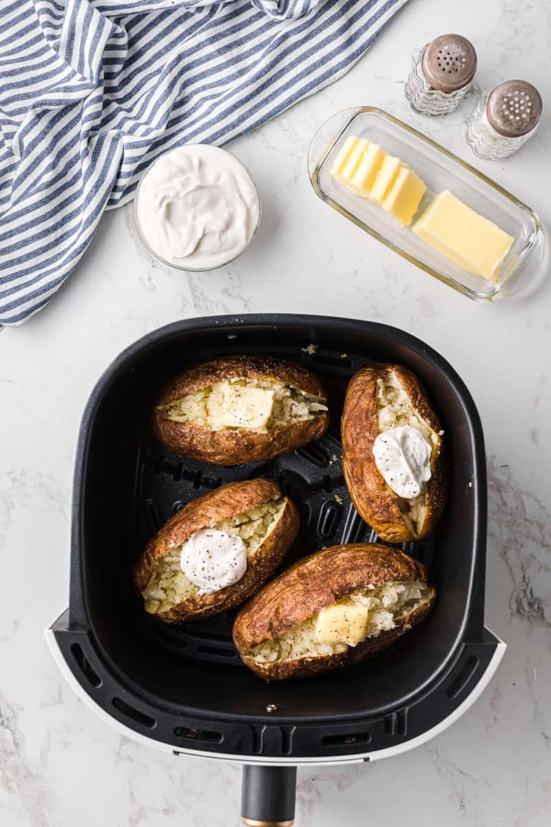 Potatoes cooked in the Air Fryer topped with butter and sour cream.