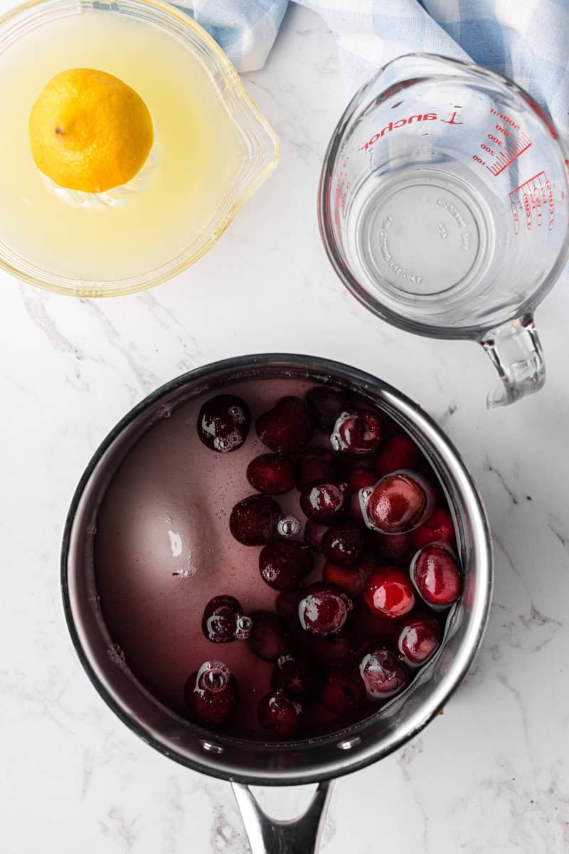 bringing cherries and sugar to a boil.