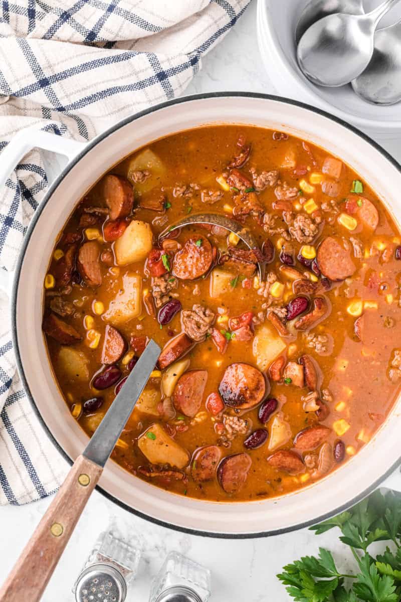 top-down view of the Cowboy Stew being served with a ladle.