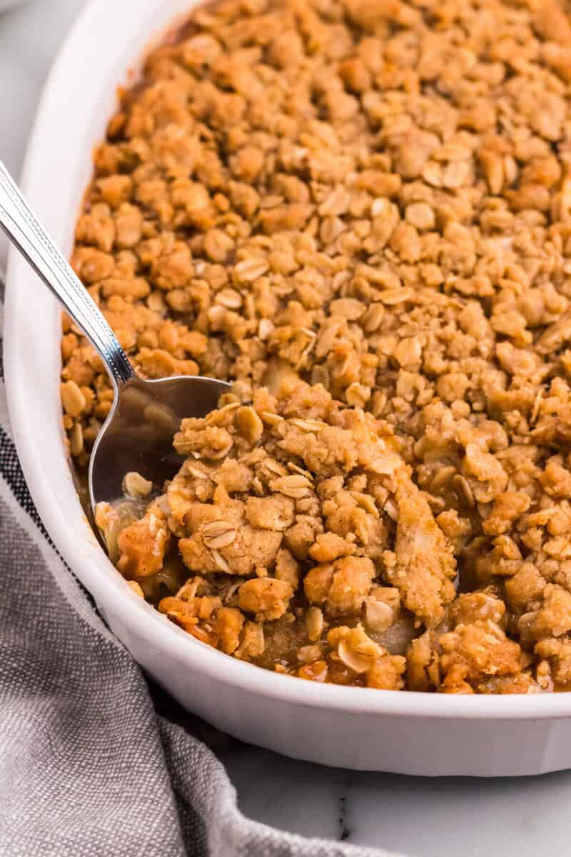 closeup of the Apple Crisp being served with a metal spoon.