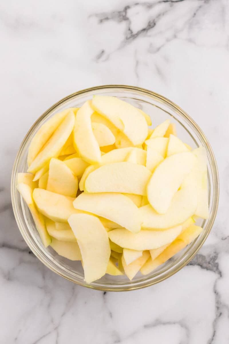 sliced apples in large glass bowl.