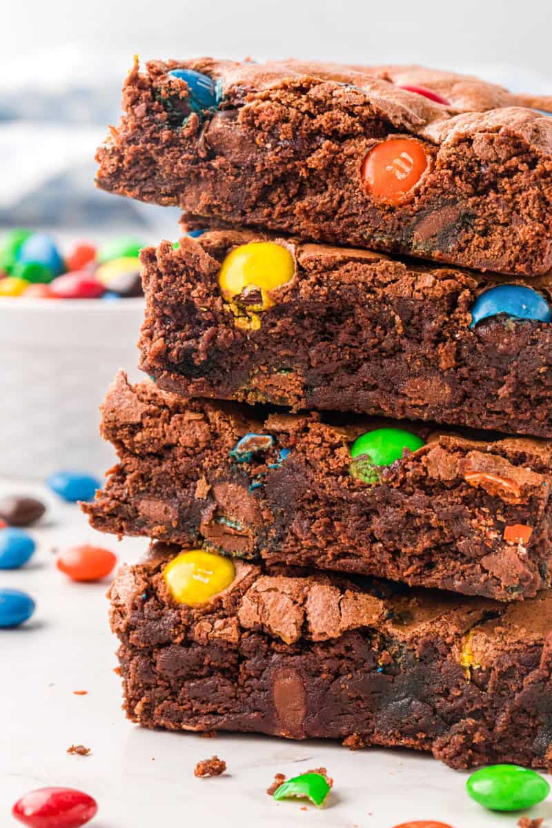 closeup of M&M Brownies stacked on top of each other.