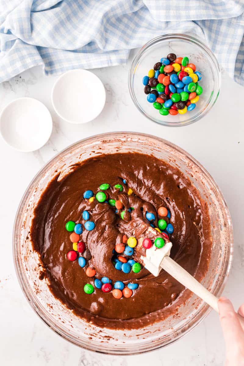 mixing in the M&Ms to the brownie batter.