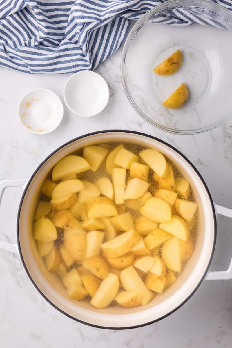 diced potatoes in white pot for boiling.