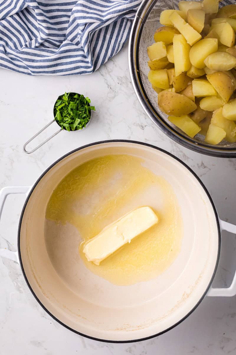 melting butter in the pot while the potatoes drain.