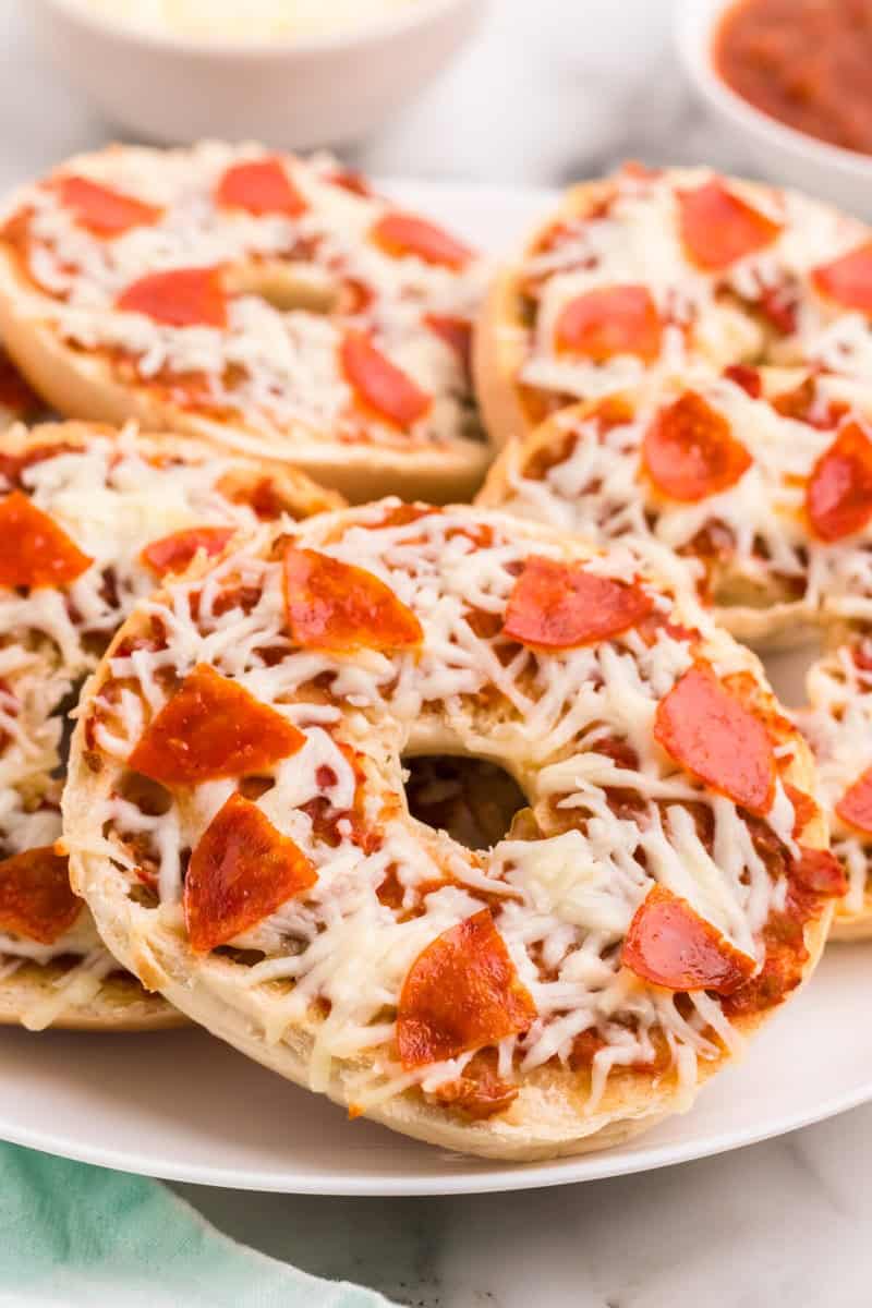 closeup of the pizza bagels on a white serving tray.