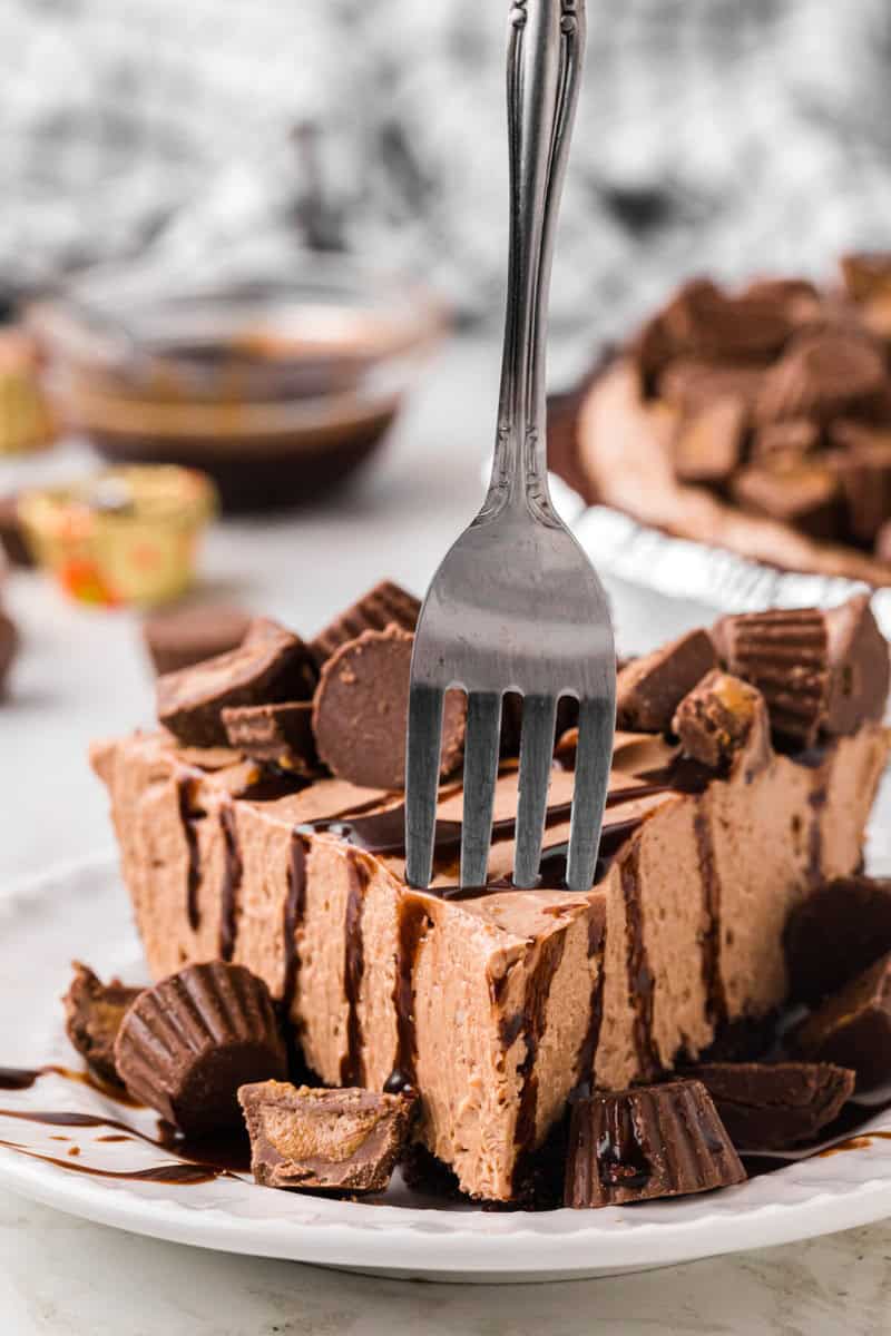 taking a bite of the Reese's Pie with a metal fork.