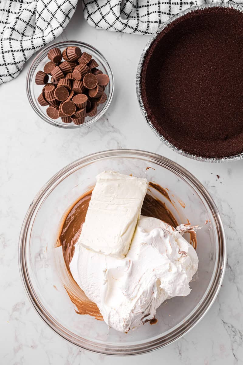 mixing the whipped topping and cream cheese into the melted Reese's.
