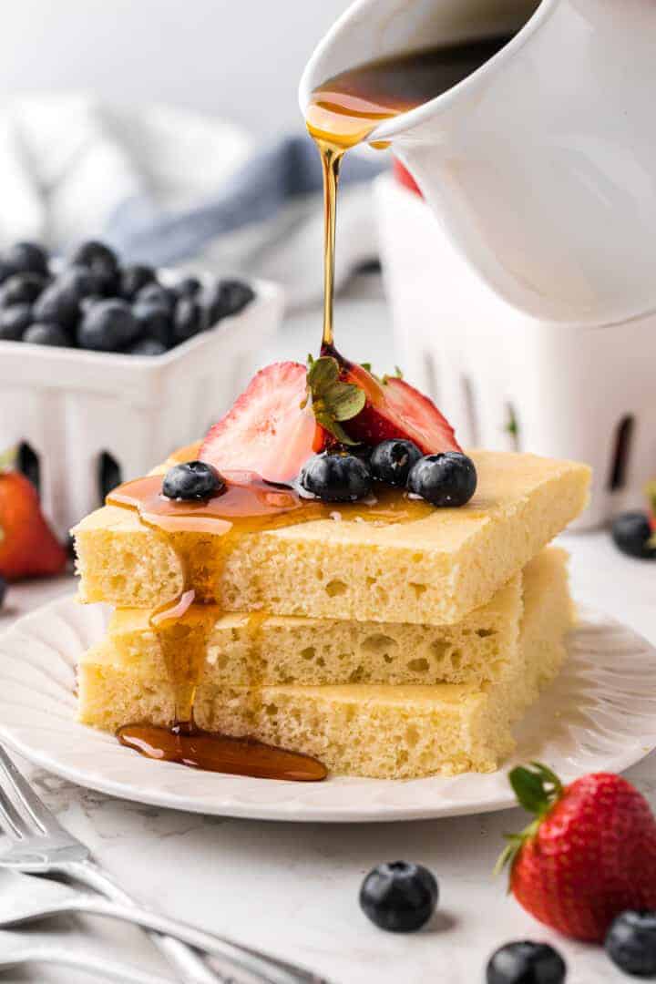 Sheet Pan Pancake squares served on a white plate.