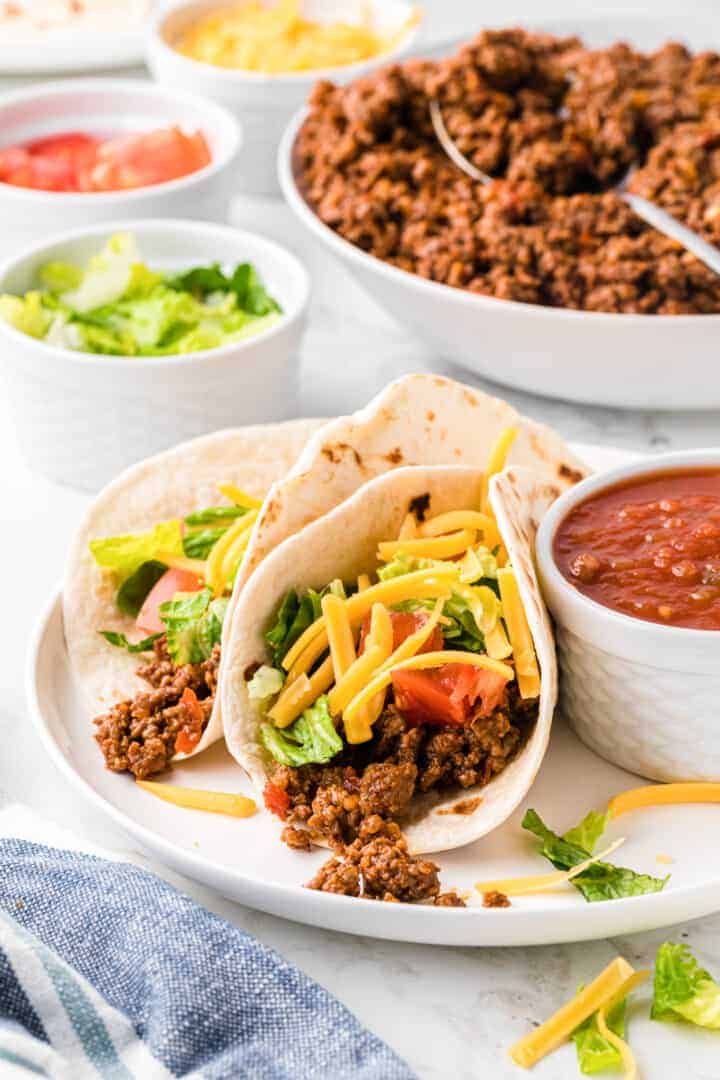 closeup of two ground beef soft tacos.