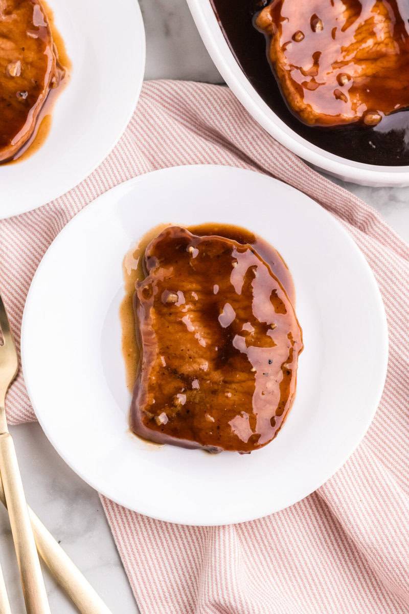 teriyaki pork chop on white plate.