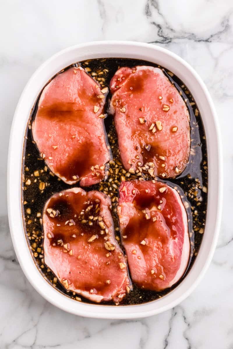 teriyaki pork chops in white baking dish.