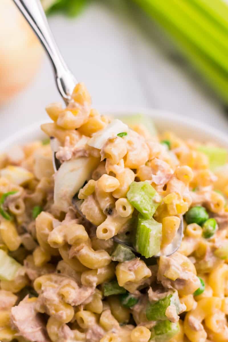 serving the Tuna Macaroni Salad with a metal spoon.