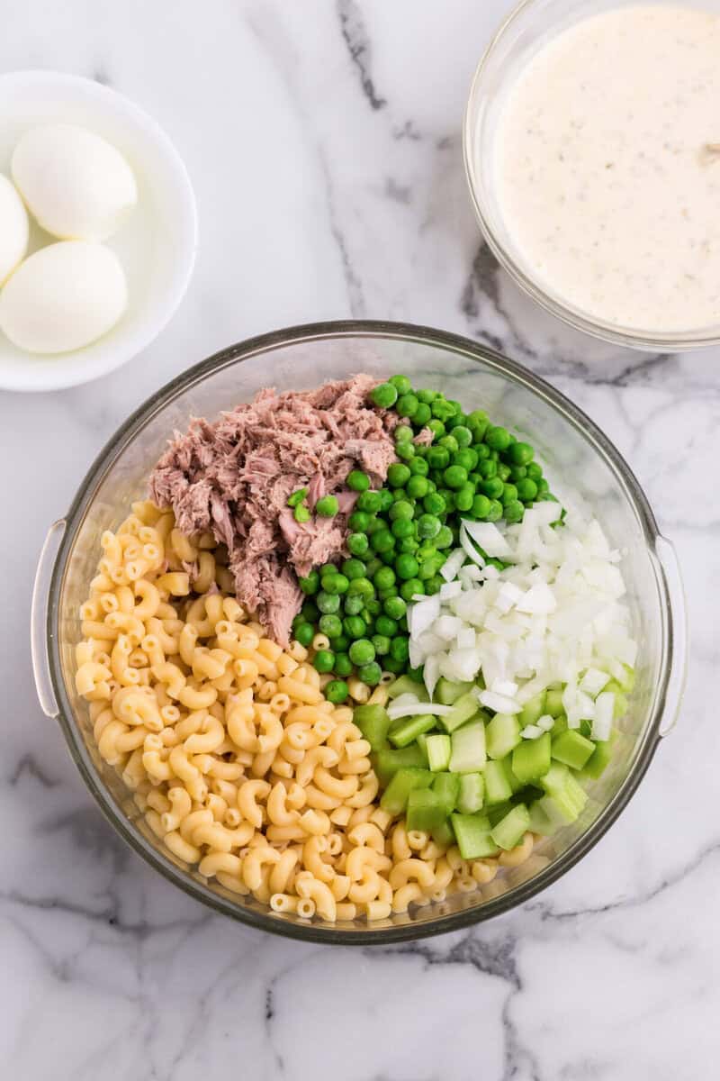 ingredients for the macaroni salad in large glass bowl.