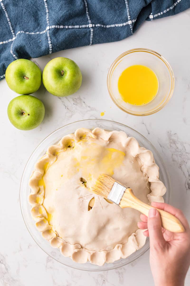 brushing the top of the pie with the egg wash.