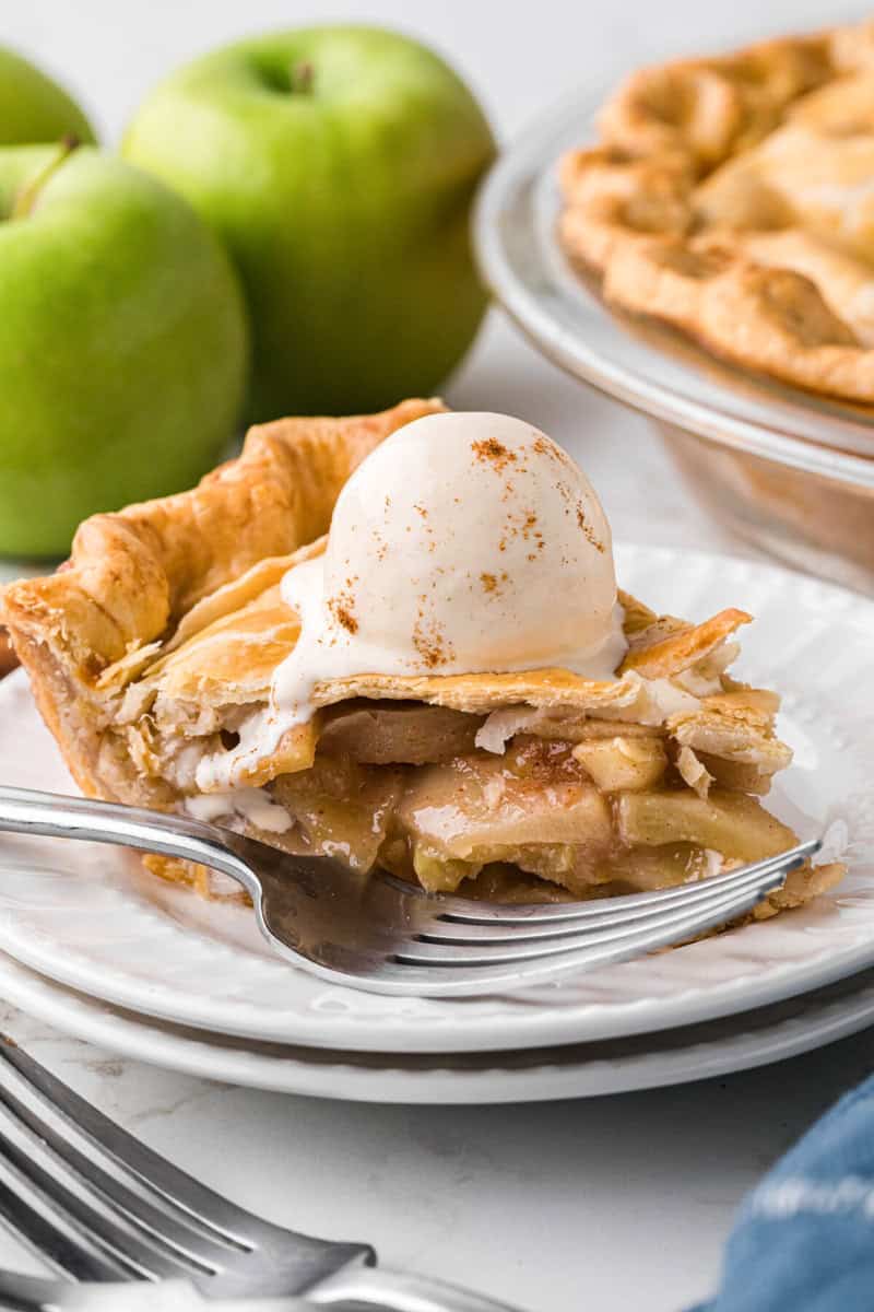 slice of the apple pie topped with ice cream.