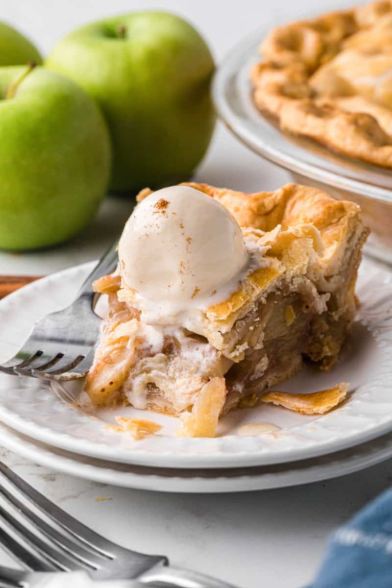 bite of the apple pie taken out of the slice.