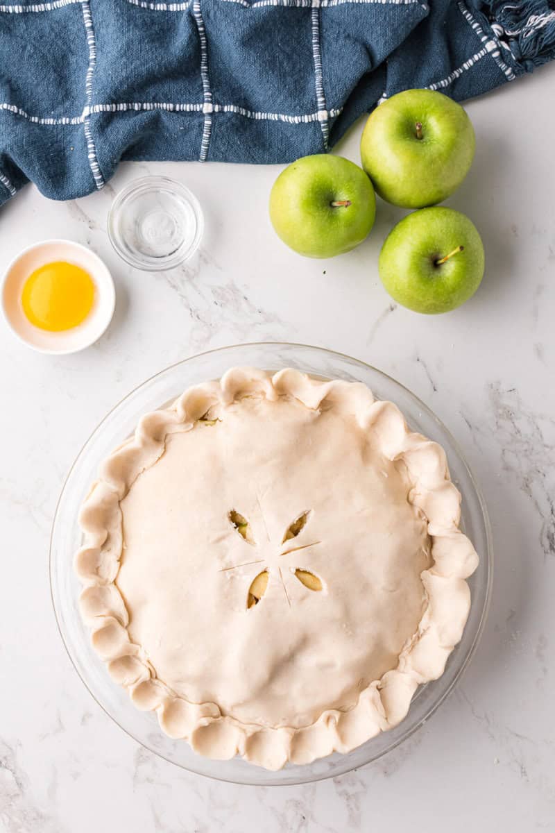 top pie crust with sliced design in it before baking.