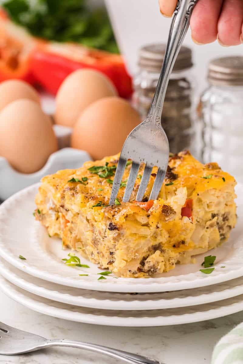 using a fork to eat the breakfast casserole.