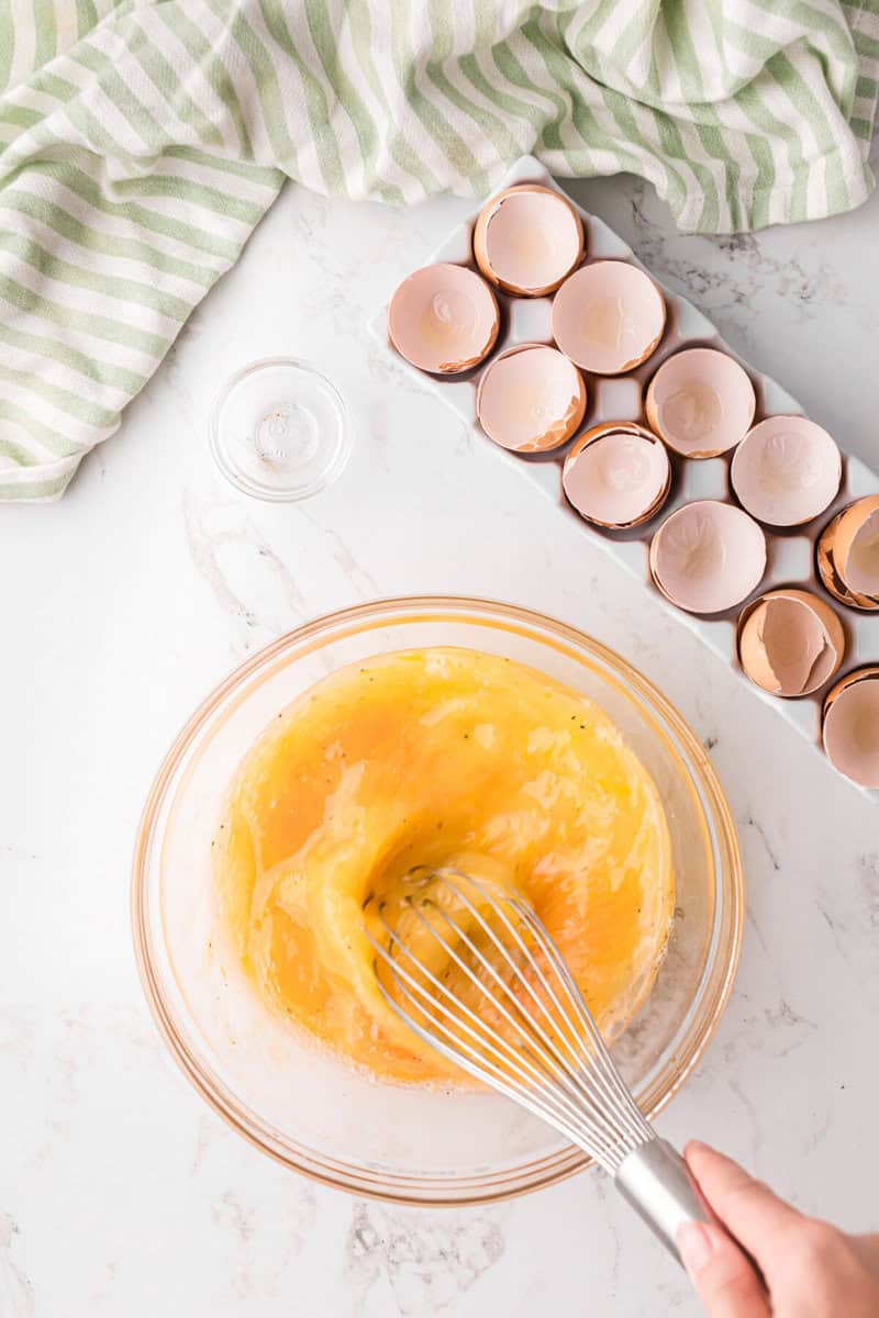 mixing the eggs for the casserole.