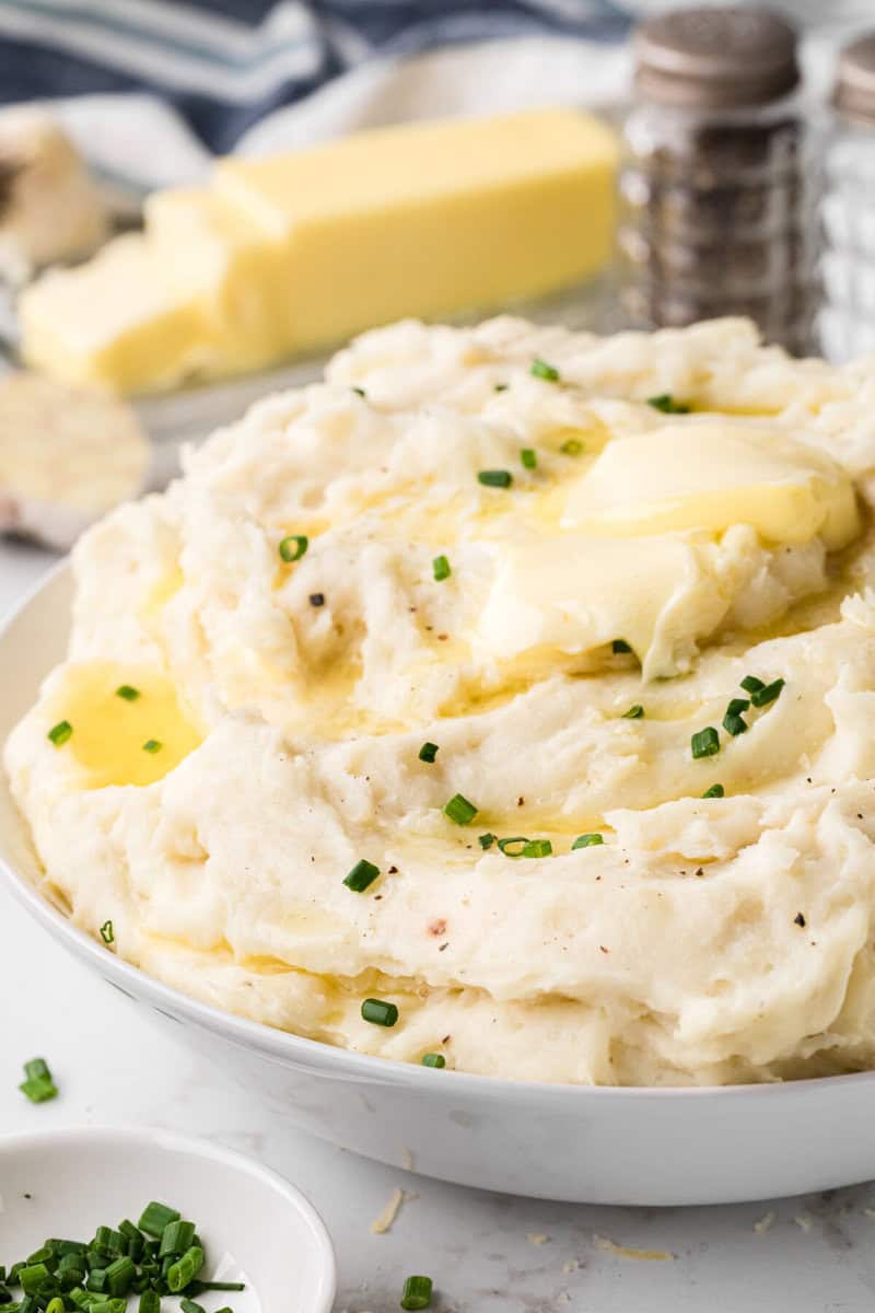 closeup of the garlic mashed potatoes in white bowl.