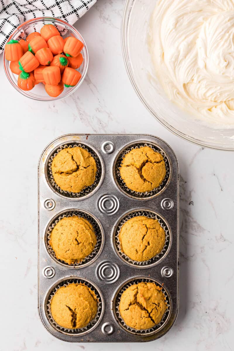 baked pumpkin cupcakes in the cupcake pan.