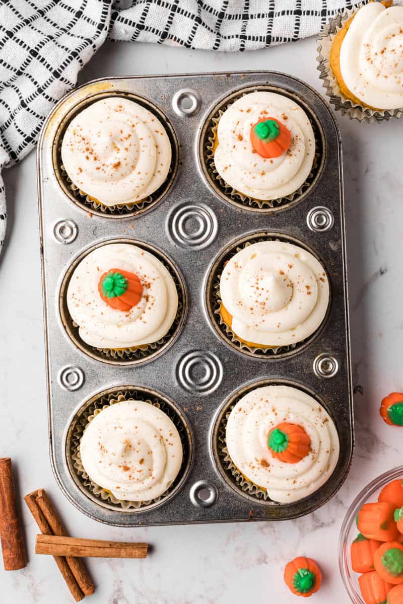 decorated pumpkin cupcakes in the cupcake pan.