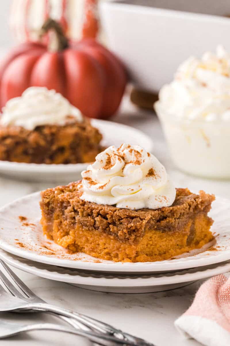 slice of the pumpkin spice dump cake served on a white plate.