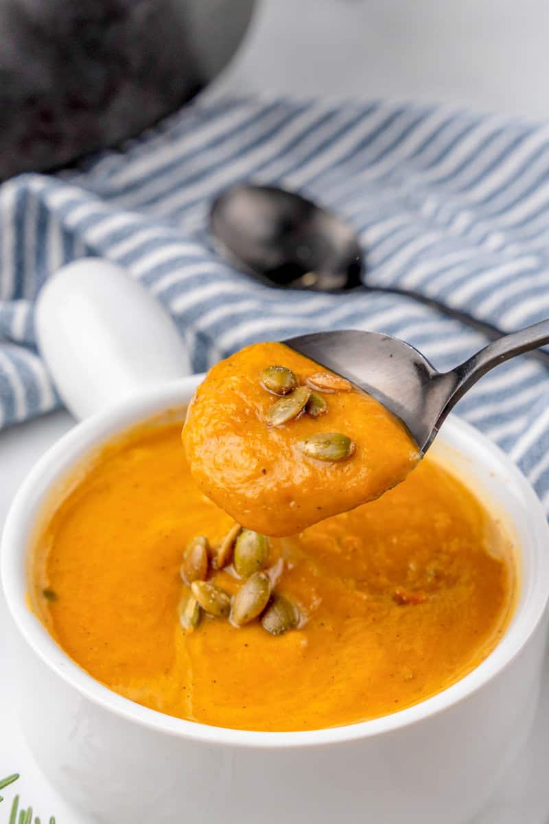 using a spoon to eat the soup.