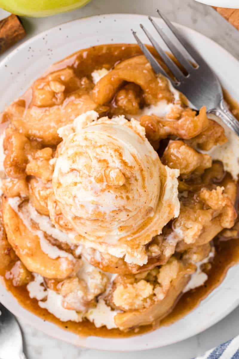 top-down view of apple cobbler topped with vanilla ice cream.