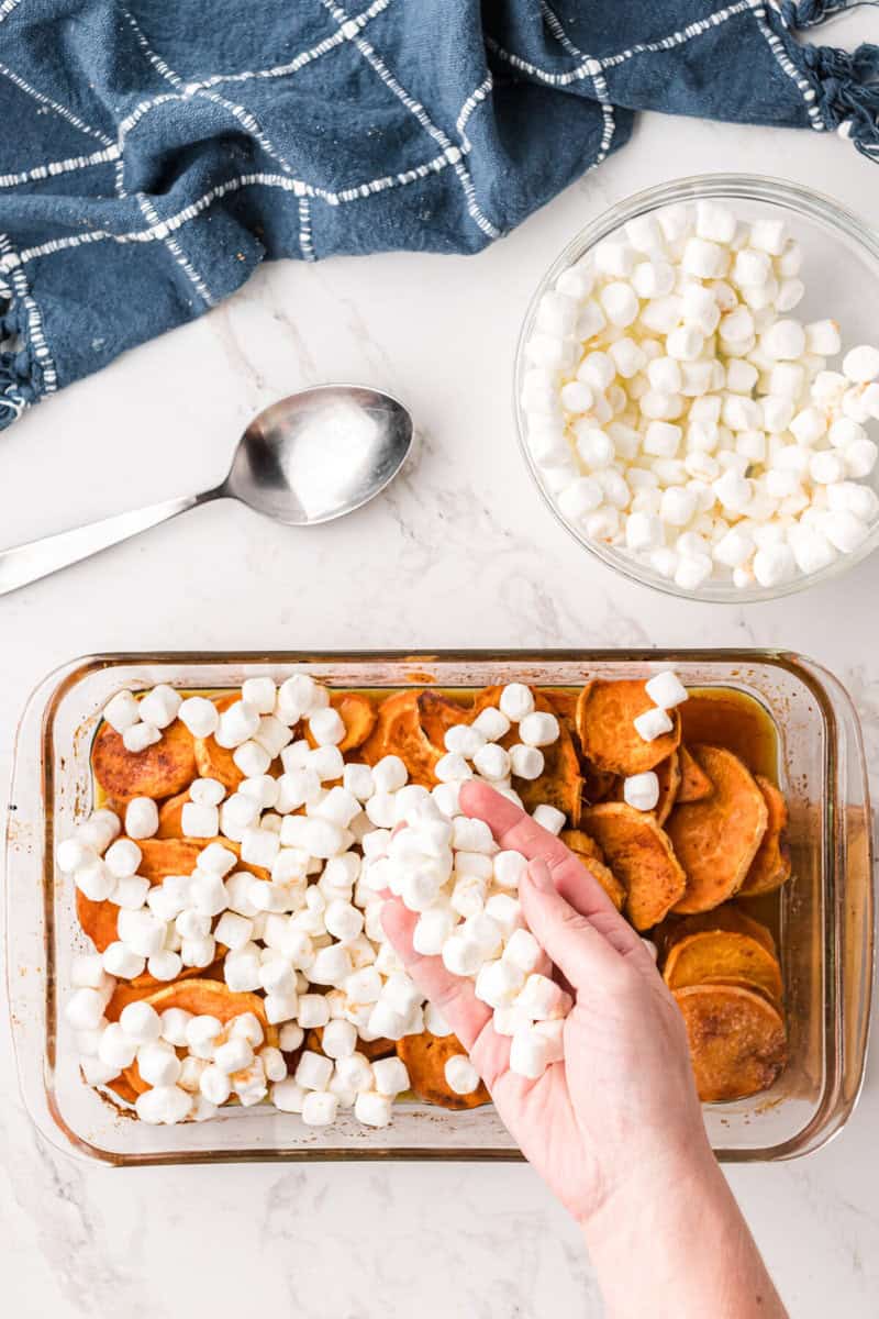 topping the yams with the marshmallows.