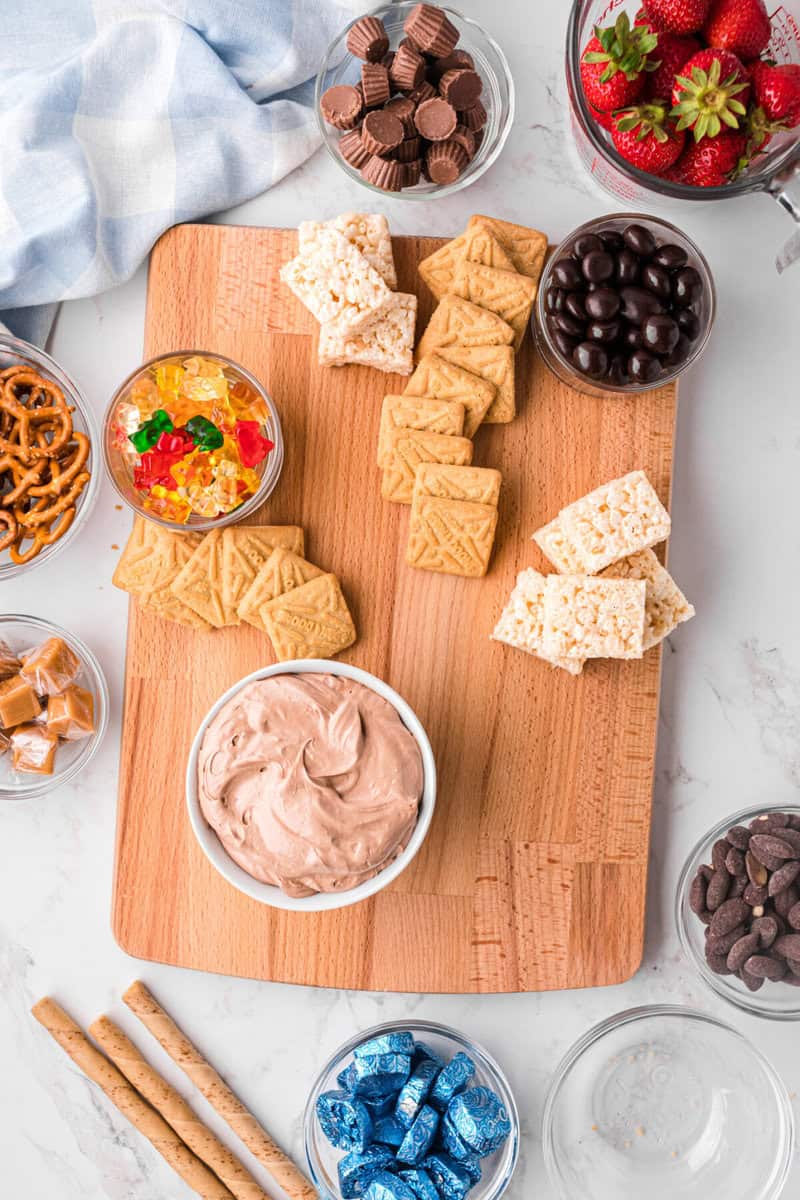 adding the larger cookies and rice Krispies to the board.