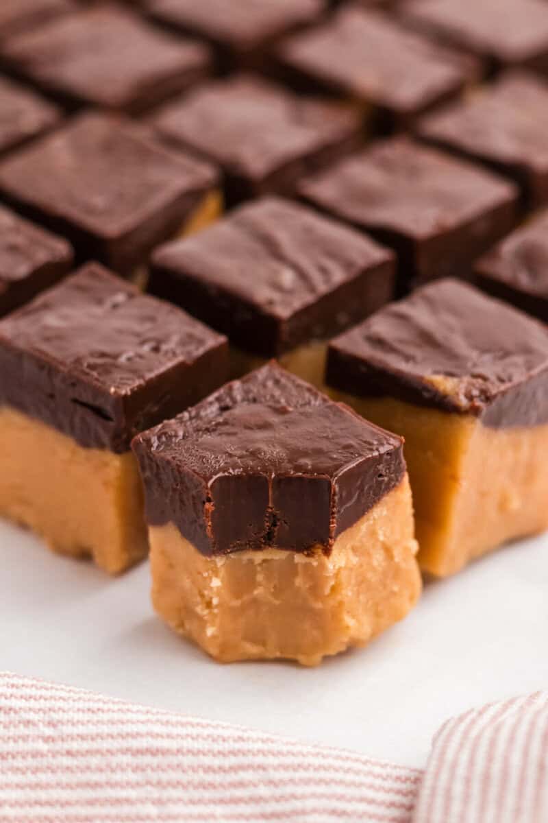 closeup of the peanut butter and chocolate fudge with a small bite taken out of one.