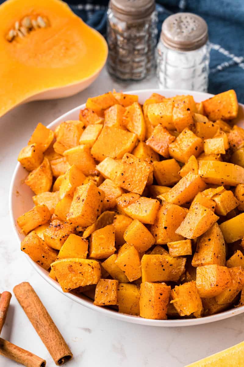 roasted butternut squash served in a large white bowl.