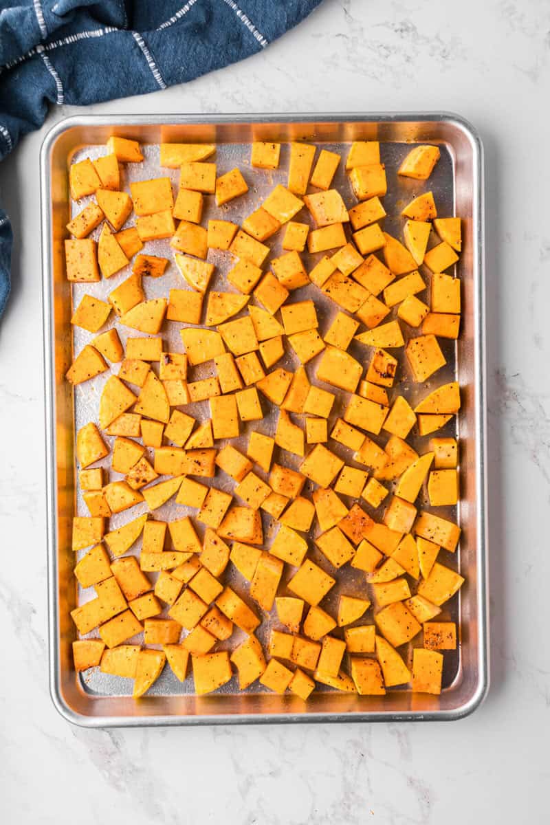 seasoned butternut squash on the baking sheet.