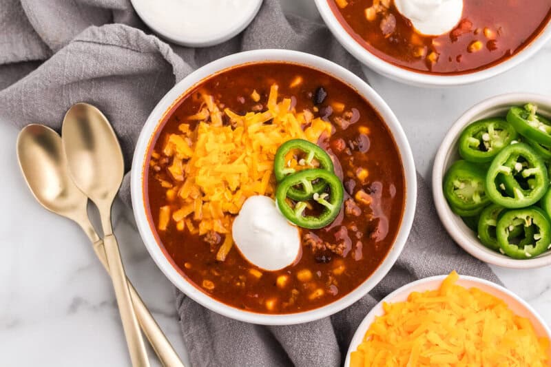 top-down view of taco soup in a white bowl.
