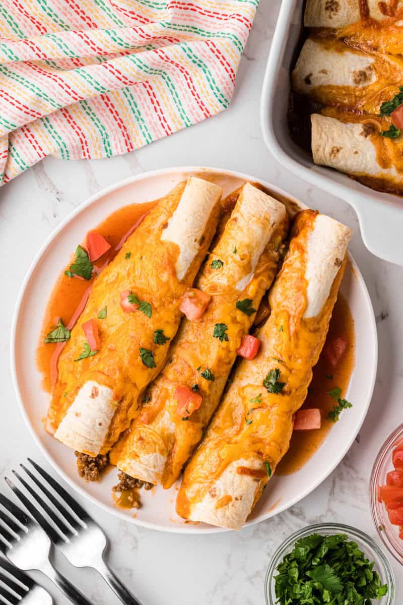 three beef enchiladas served on a white plate.