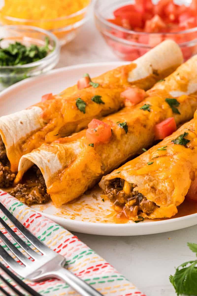 closeup of the beef enchiladas on white plate.