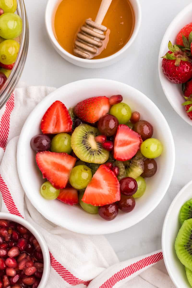 closeup of the Christmas Fruit Salad served in a white bowl.