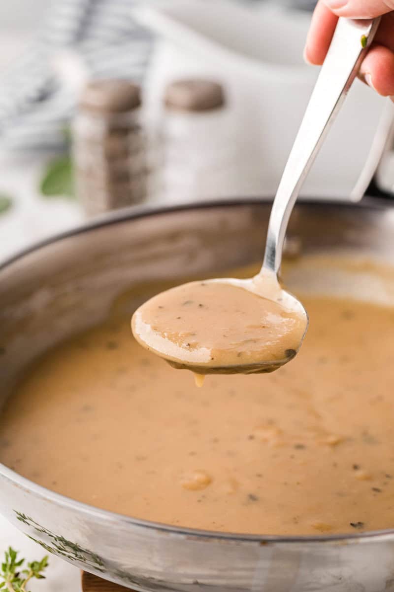 using a ladle to serve the gravy.