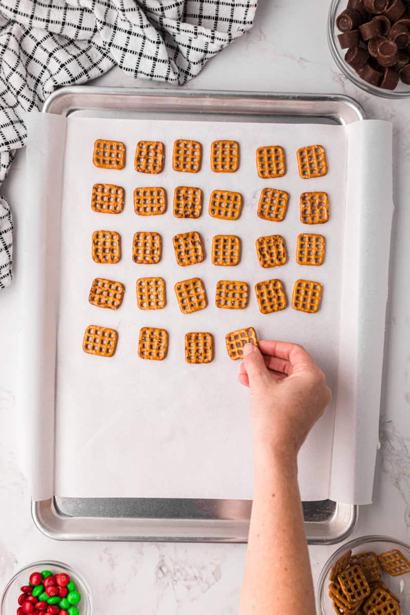 placing the pretzel squares on the baking sheet.
