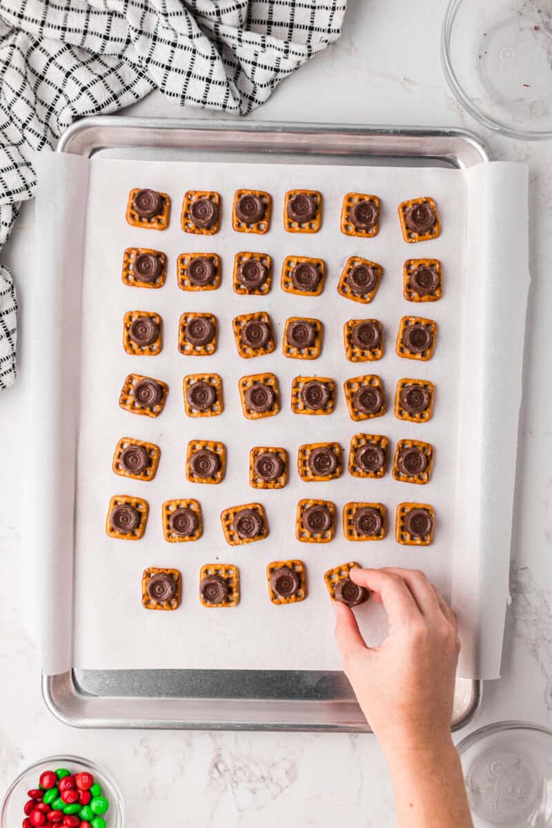 placing a Rolo on top of all the pretzels.