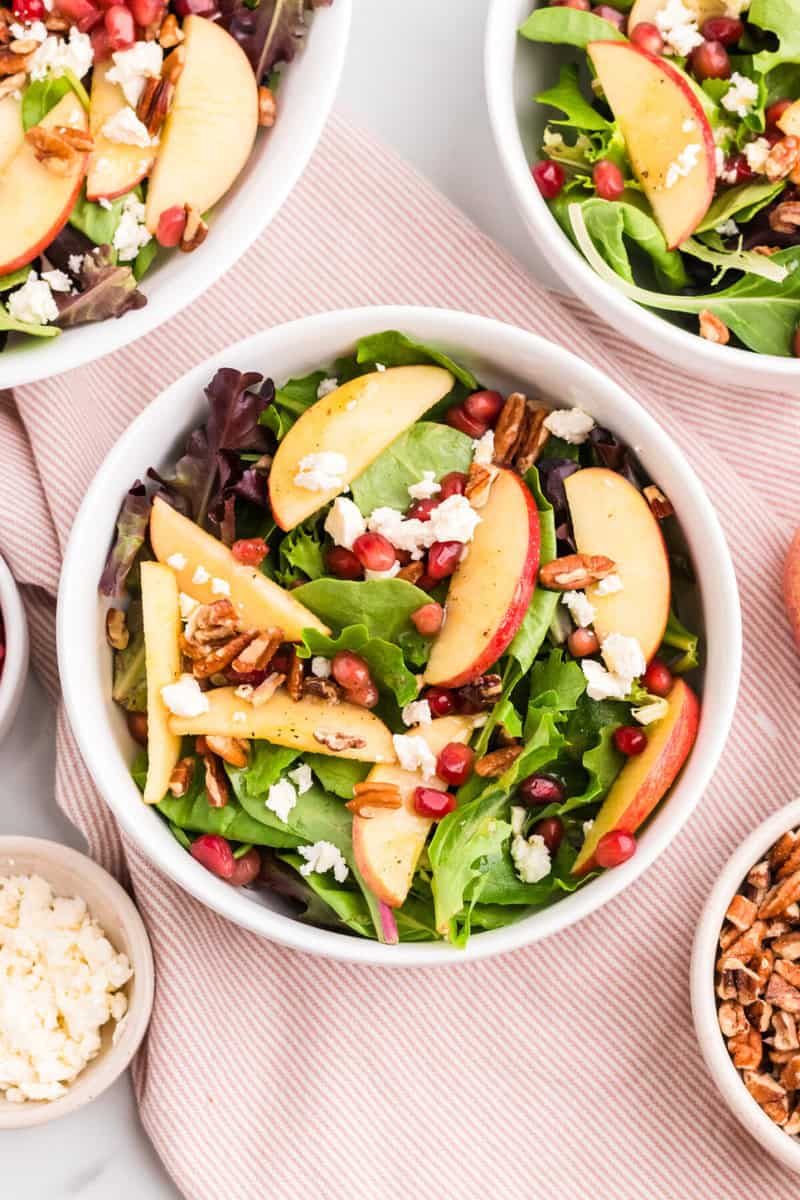 serving the Thanksgiving Salad in a white bowl.