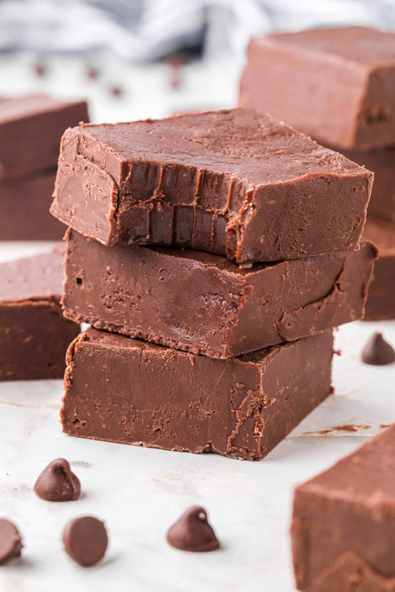 closeup of the stacked chocolate fudge with the top one with a small bite out of it.