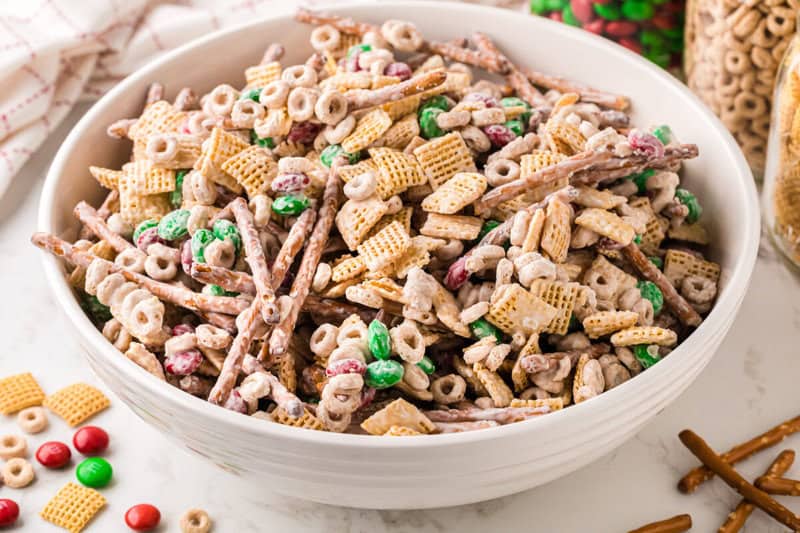 The Christmas Chex Mix served in large white bowl.