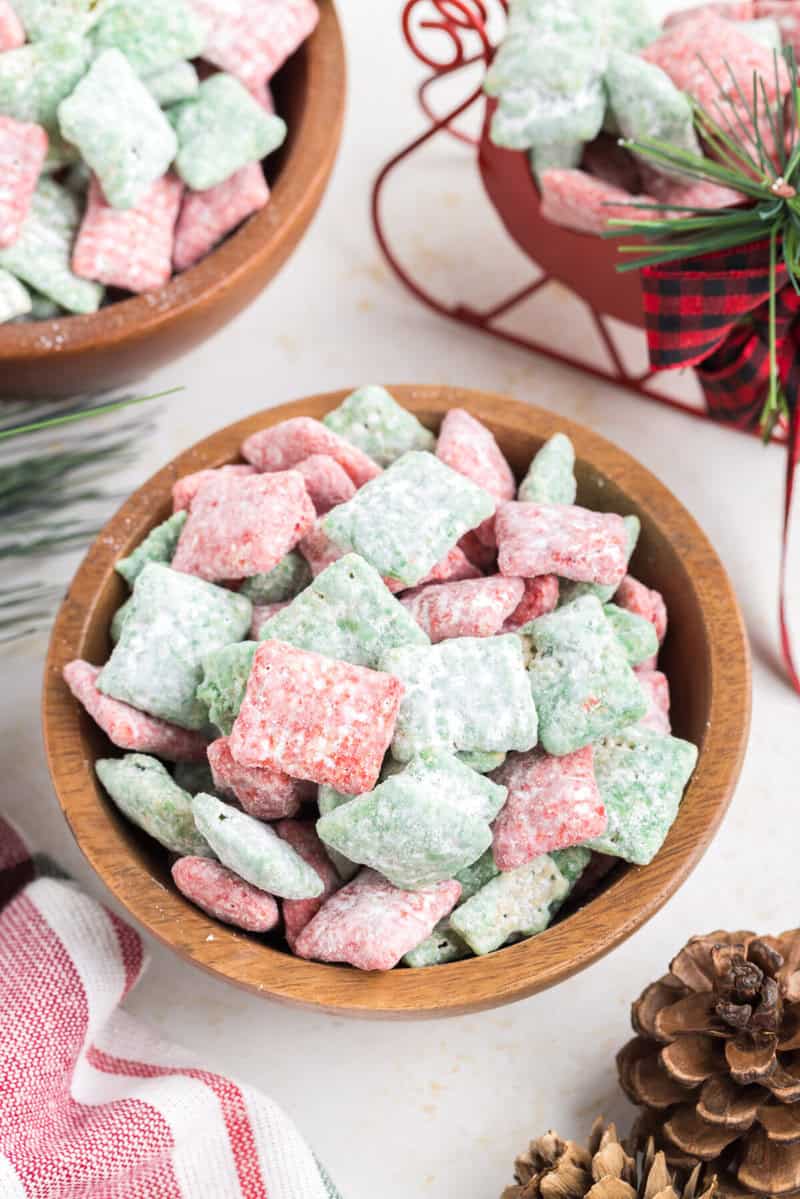 closeup of a small wooden bowl of the Christmas Puppy Chow.