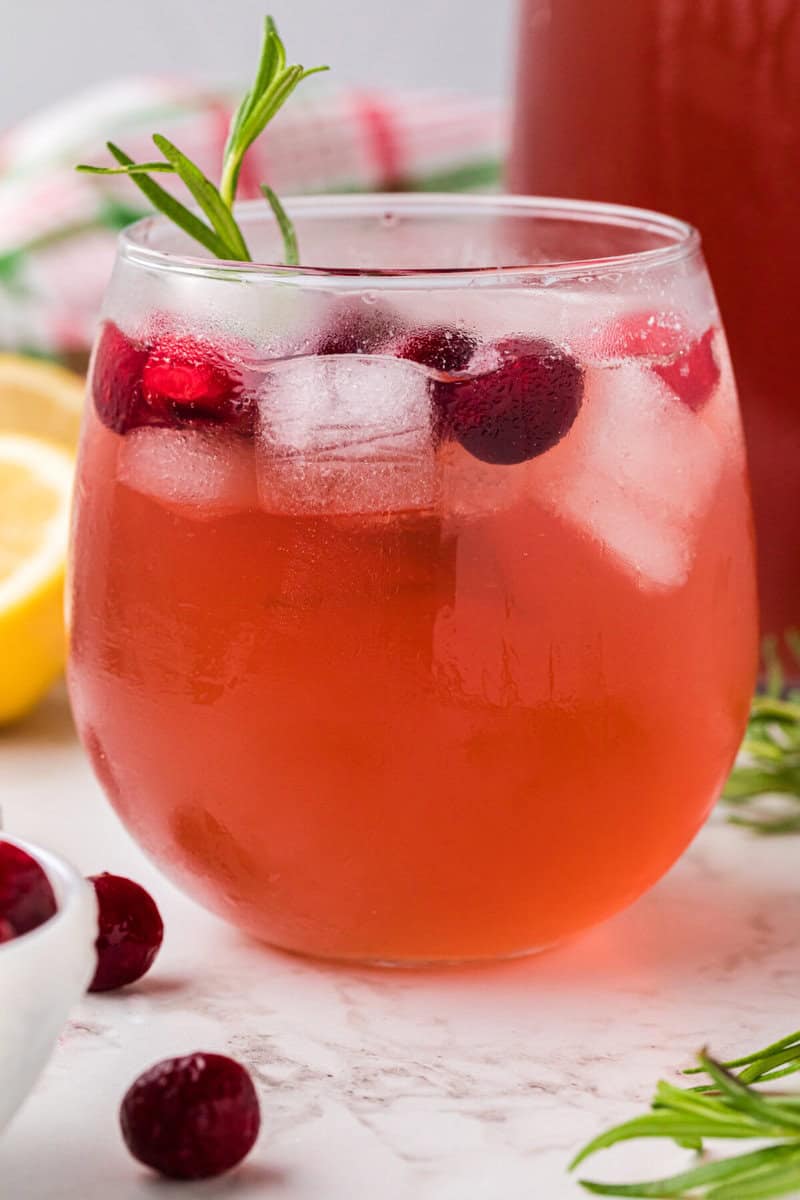 glass of the Christmas Punch with ice and cranberries in it.