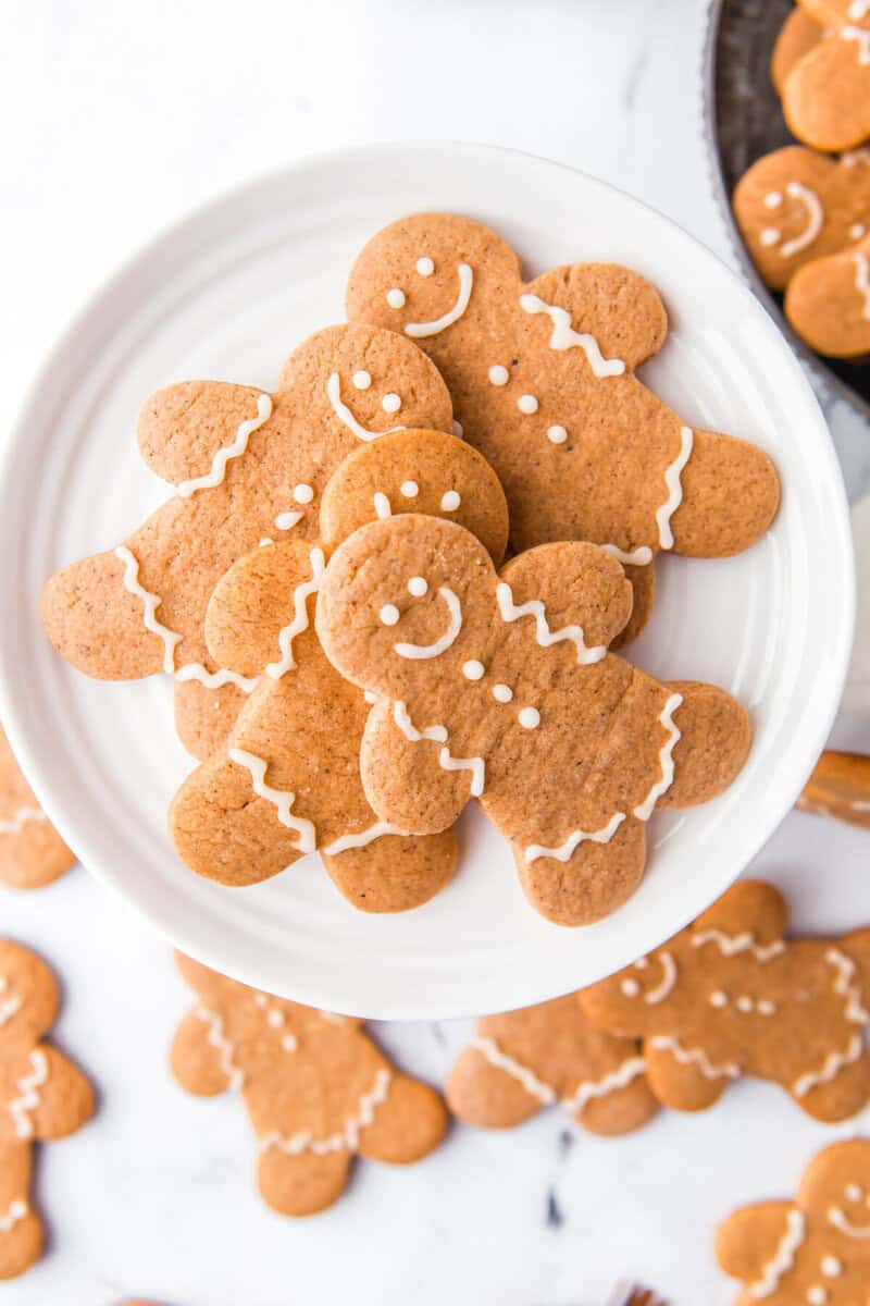 closeup of the gingerbread men cookies served on a white plate.